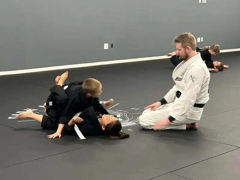 Coach Korey working with kids during the Dark Matter Cadets jiu-jitsu class in Tempe Arizona
